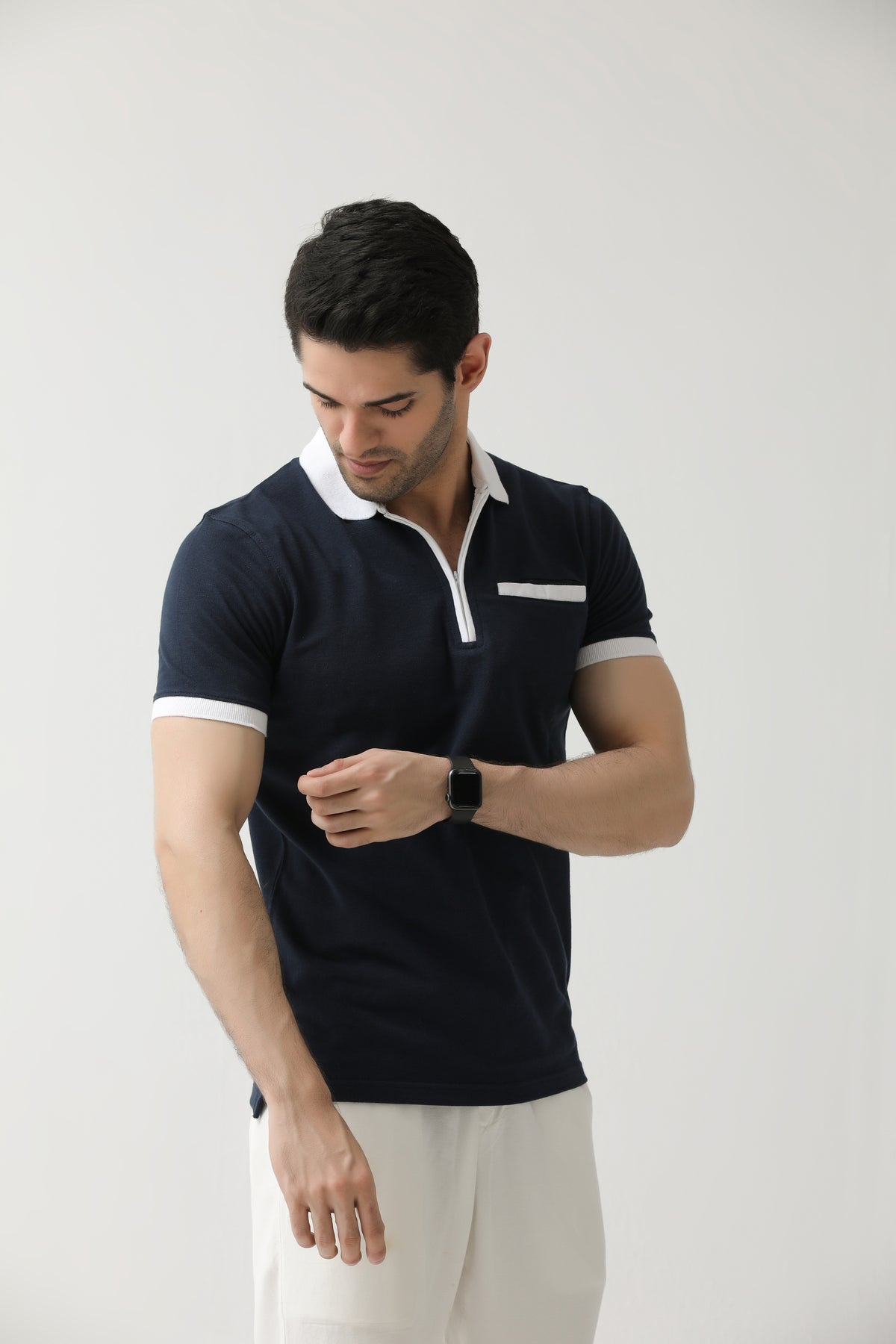 Navy blue zip neck polo shirt with white contrast collar, front view